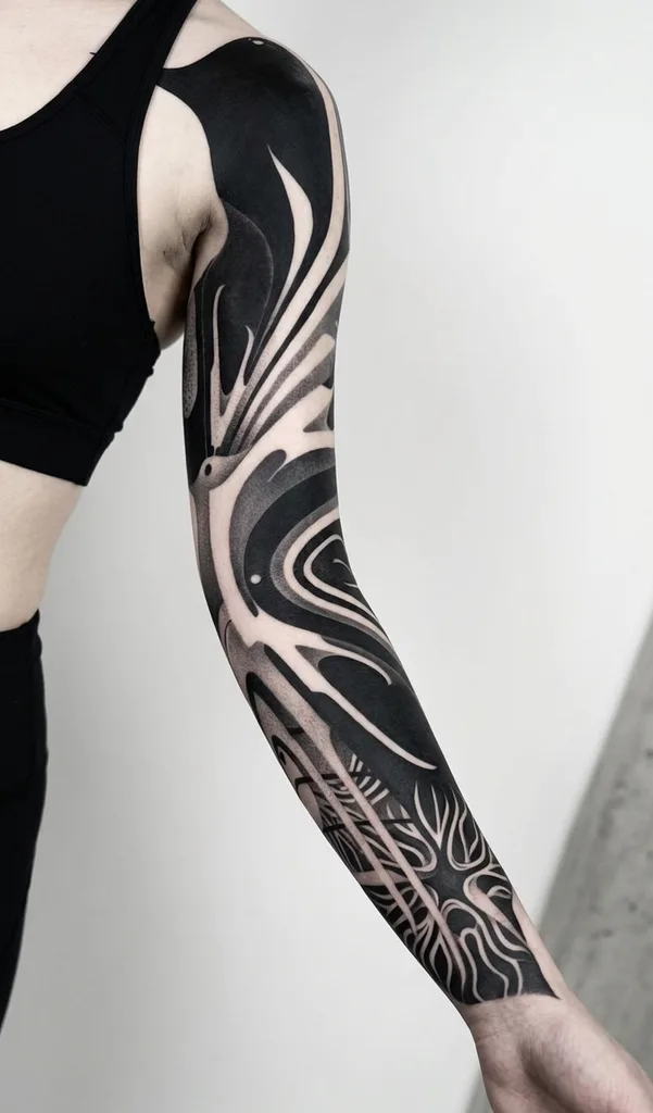 Abstract patterns tattoo design for women, blackwork style, on the full sleeve, with contrasting black and white organic shapes, featuring flowing lines and intricate details