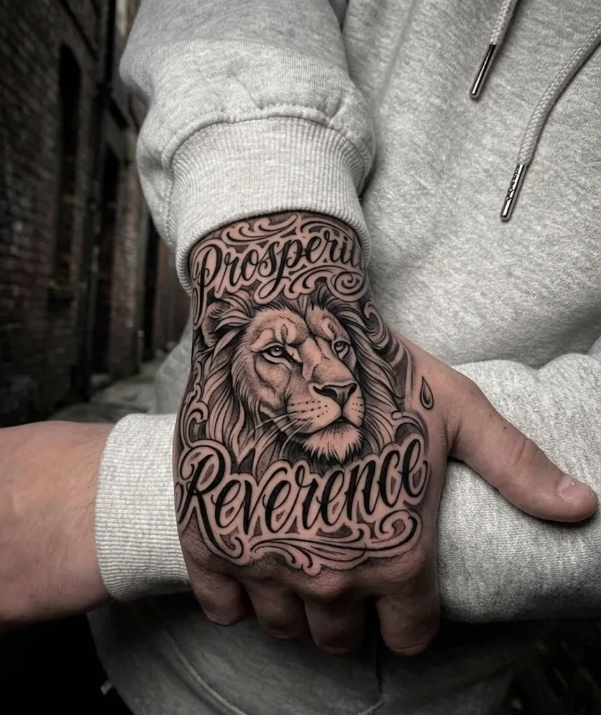 Lion tattoo design for men, Chicano style, on the hand, with calligraphic lettering above and below, surrounded by filigree details