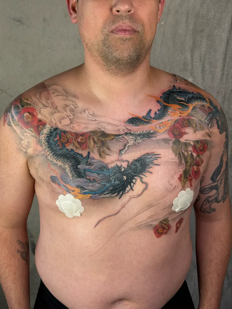 Dragon roses tattoo design for men, Japanese style, on the chest, flying through clouds and red flowers, with some parts outlined in orange